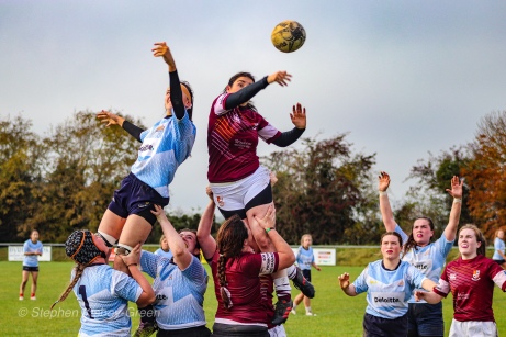 Claire Kealy and Katie O'Brien lift Sophie Kilburn as she reaches across the lineout for the ball. Photo: Stephen Kisbey-Green