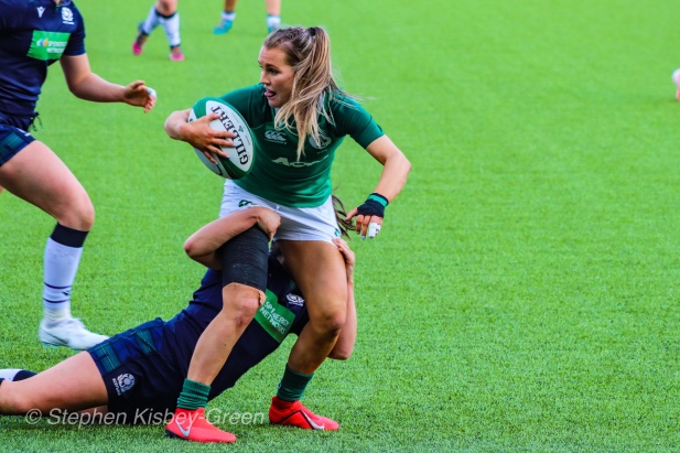 Aoife Doyle looks for support while being tackled by Scotland. Photo: Stephen Kisbey-Green