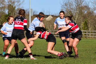 Claire Kealy crashes the ball up for DCU into some solid defense by Wicklow RFC. Photo: Stephen Kisbey-Green